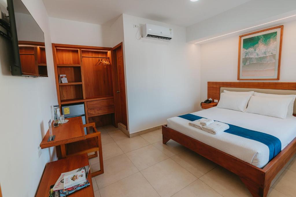 Postel nebo postele na pokoji v ubytování Hotel Ninfa