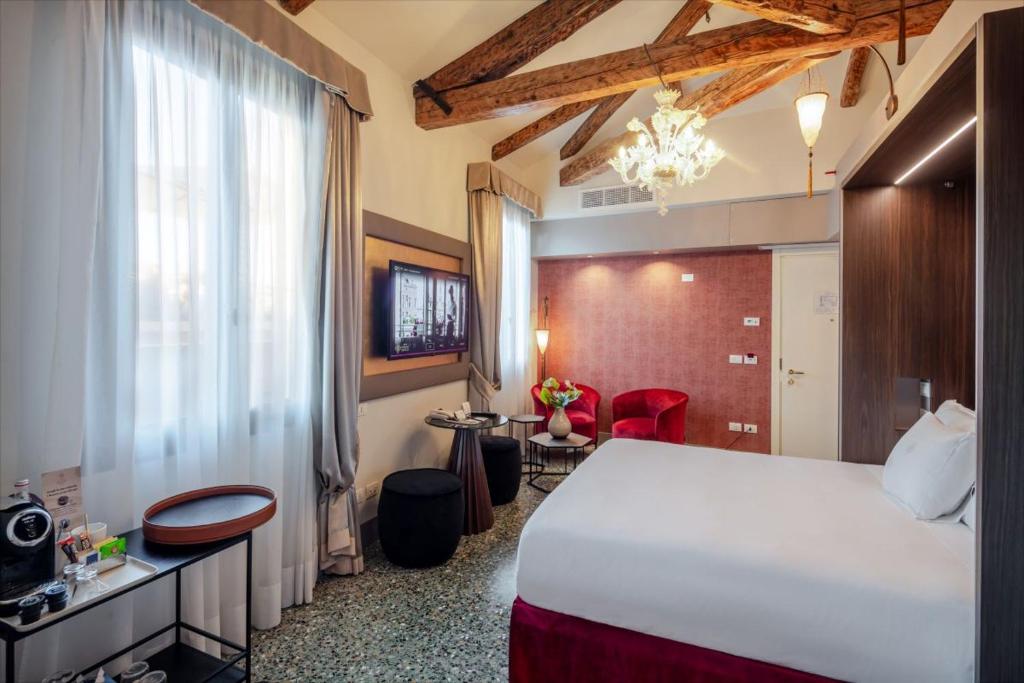 a hotel room with a large bed and a window at Palazzo Barocci in Venice