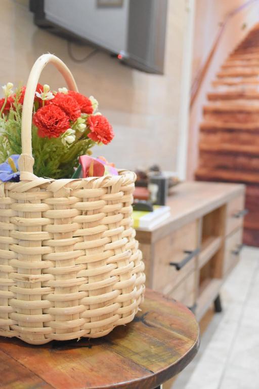 a basket of flowers sitting on a table in a kitchen at Panariello a Portamedina in Naples