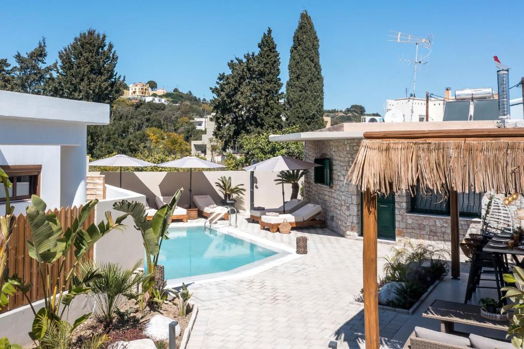 a villa with a swimming pool and a resort at Lythari Summer Villa in Afantou