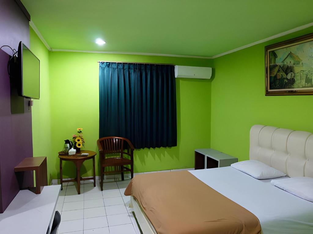 Postel nebo postele na pokoji v ubytování Super OYO Townhouse OAK Hotel Fiducia Serpong