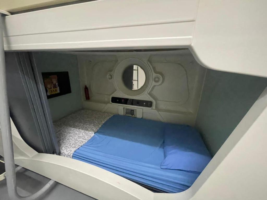 a small room with a bed on an airplane at Hotel O The Space Inn in Kuala Terengganu