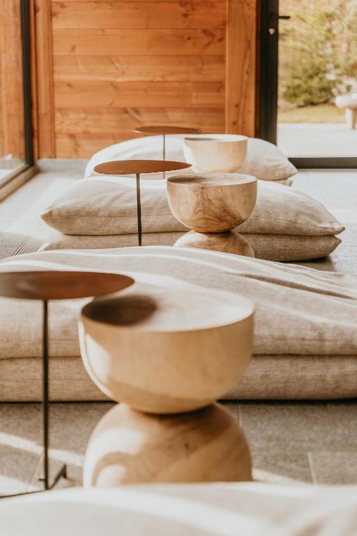 a group of wooden tables and pillows on a table at Hôtel Restaurant La Ferme de Cupelin in Saint-Gervais-les-Bains