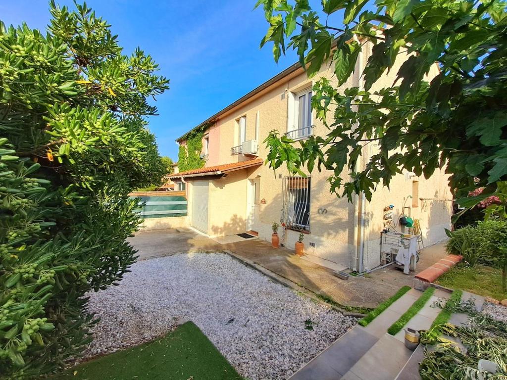 - une vue sur une maison depuis le jardin dans l'établissement Country and family villa, à Villeneuve-de-la-Raho