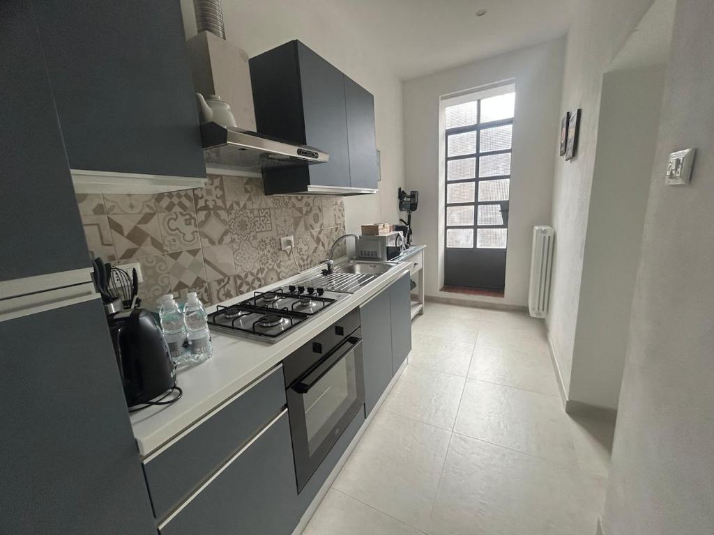 a kitchen with a stove and a stove top oven at Carradori 2 Apartment-Historic Center-Autodromo in Imola