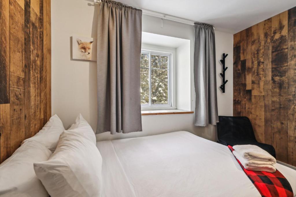Postel nebo postele na pokoji v ubytování Auberge Manitonga