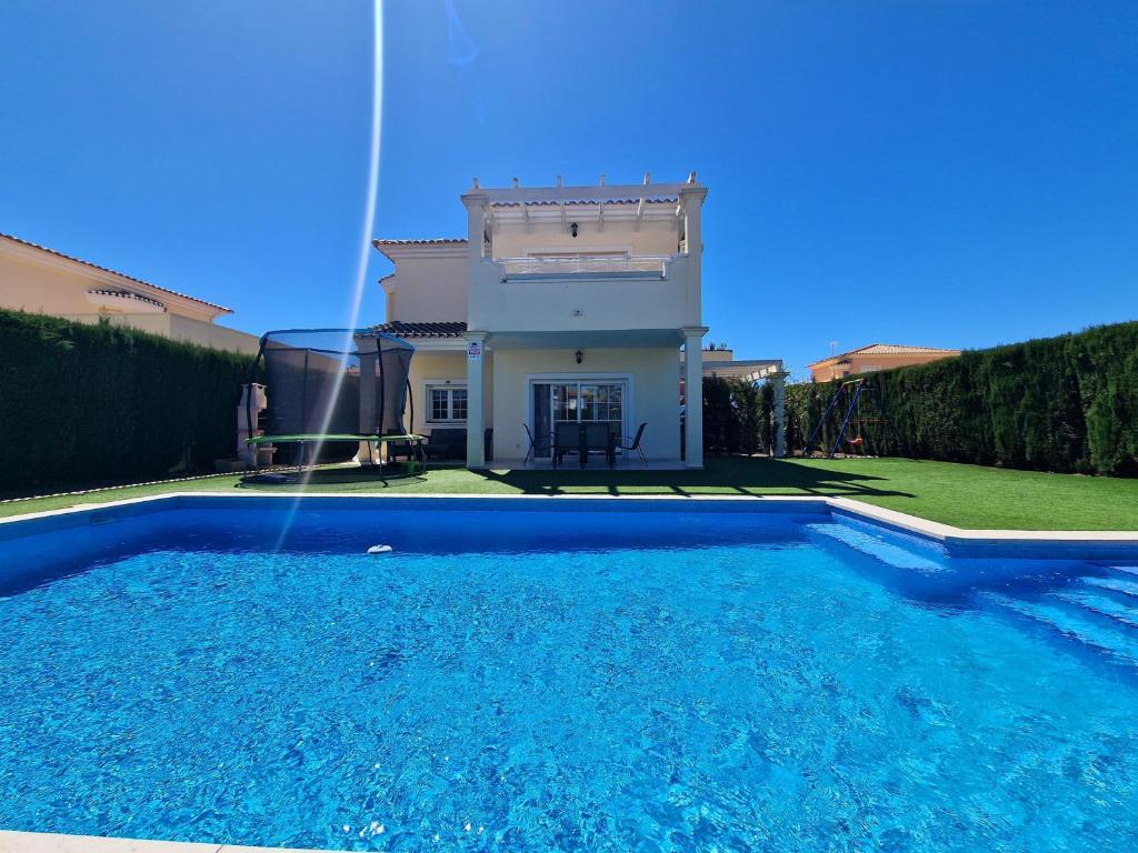 a house with a swimming pool in front of a house at Villa Sofía - 2 bedroom villa with private pool and garden in Baños y Mendigo