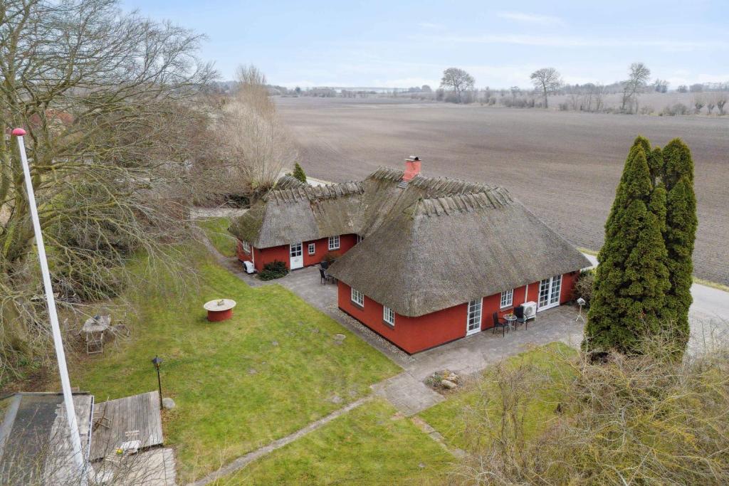 an aerial view of a red house with a roof at Spacious Holiday Home Near Nature Experiences in Otterup