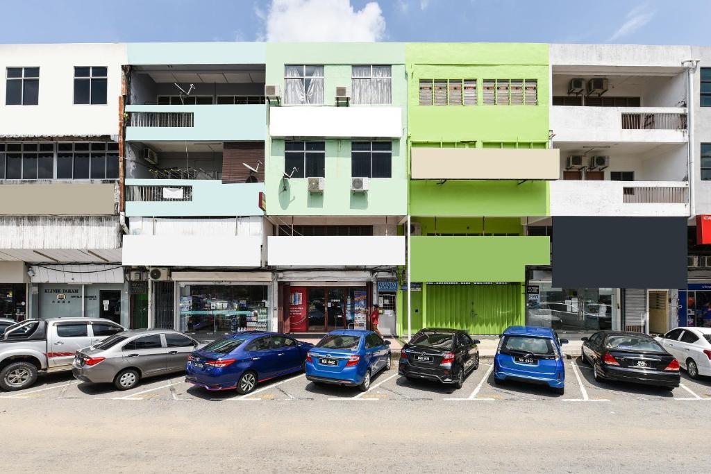 a group of cars parked in a parking lot at Hotel O Kuantan Backpackers in Kuantan