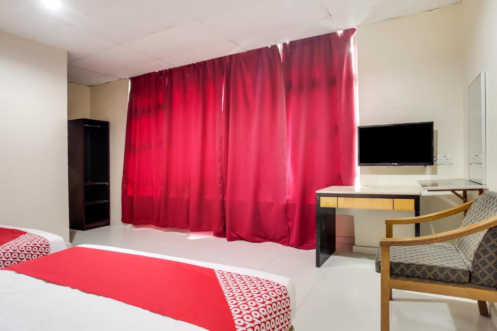 Postel nebo postele na pokoji v ubytování Super OYO 89427 Kavanas Hotel Taiping