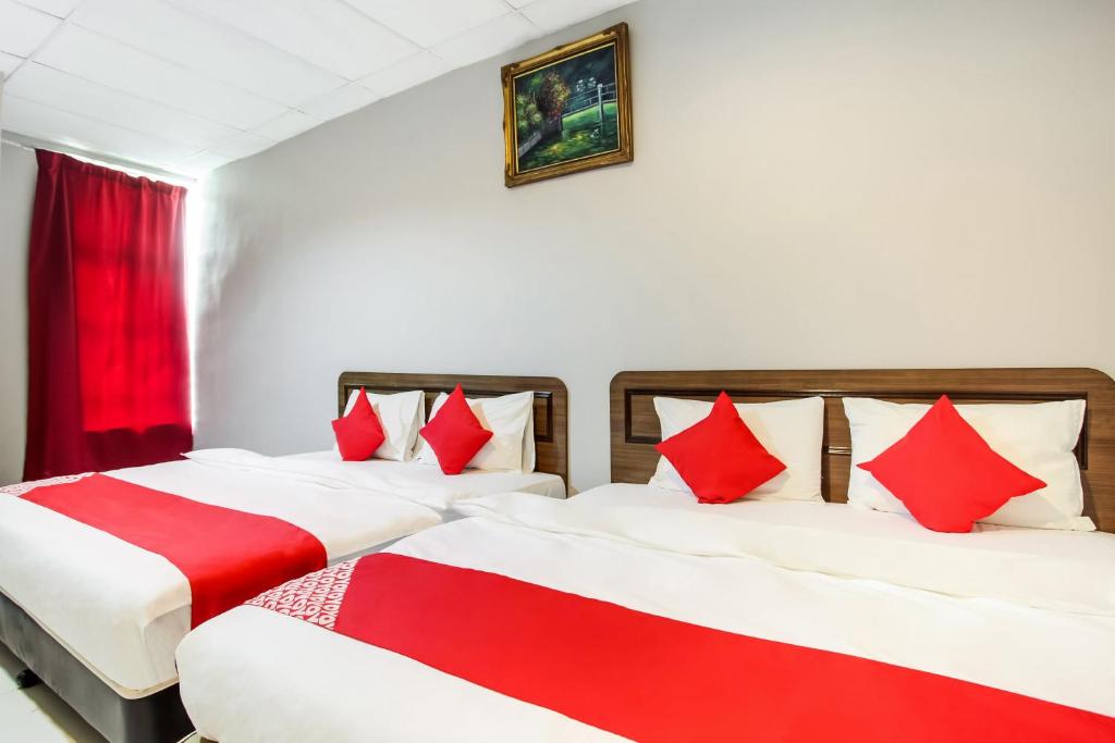 Postel nebo postele na pokoji v ubytování Super OYO 89427 Kavanas Hotel Taiping