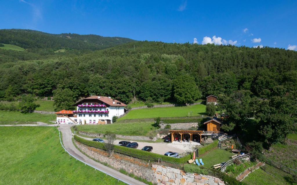 an aerial view of a house on a hill at Garni Kircher Sepp in Barbiano