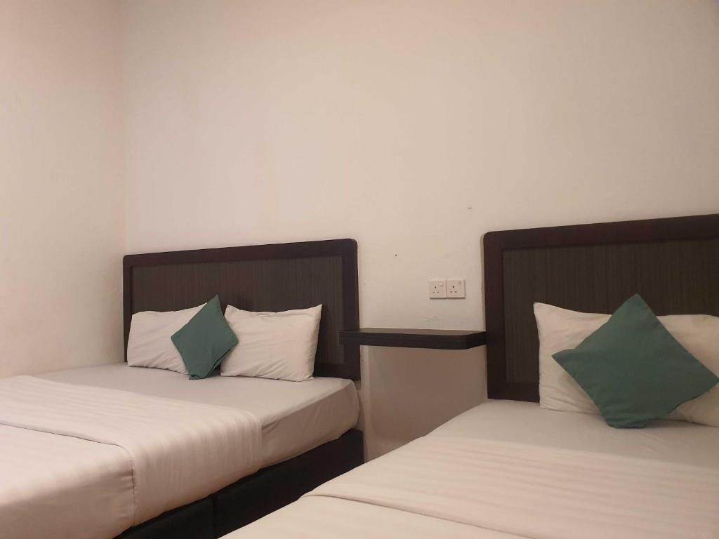 Postel nebo postele na pokoji v ubytování OYO 91053 Signature Inn Miri