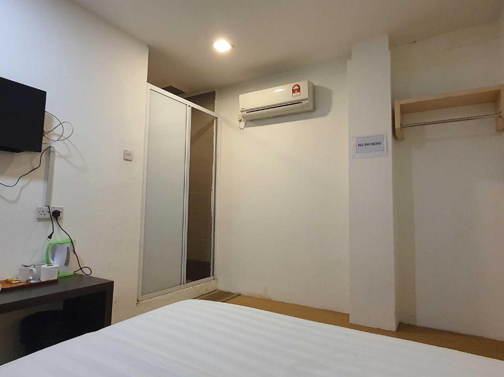 Postel nebo postele na pokoji v ubytování OYO 91053 Signature Inn Miri