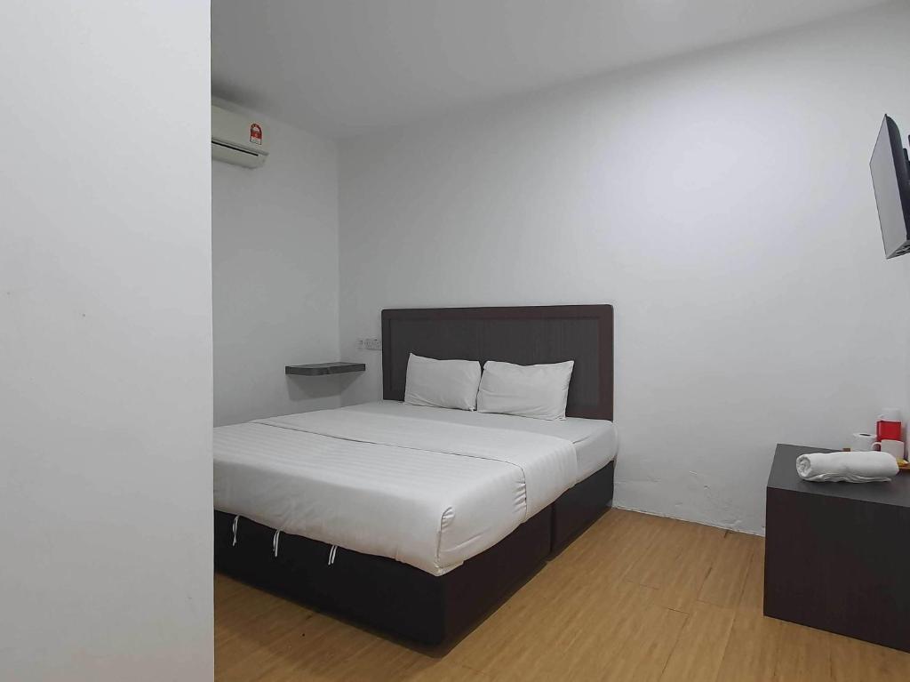 Postel nebo postele na pokoji v ubytování OYO 91053 Signature Inn Miri