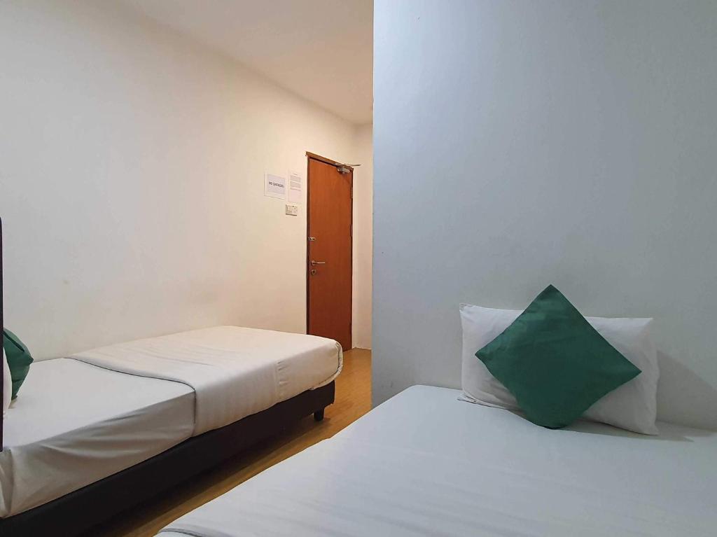 Postel nebo postele na pokoji v ubytování OYO 91053 Signature Inn Miri