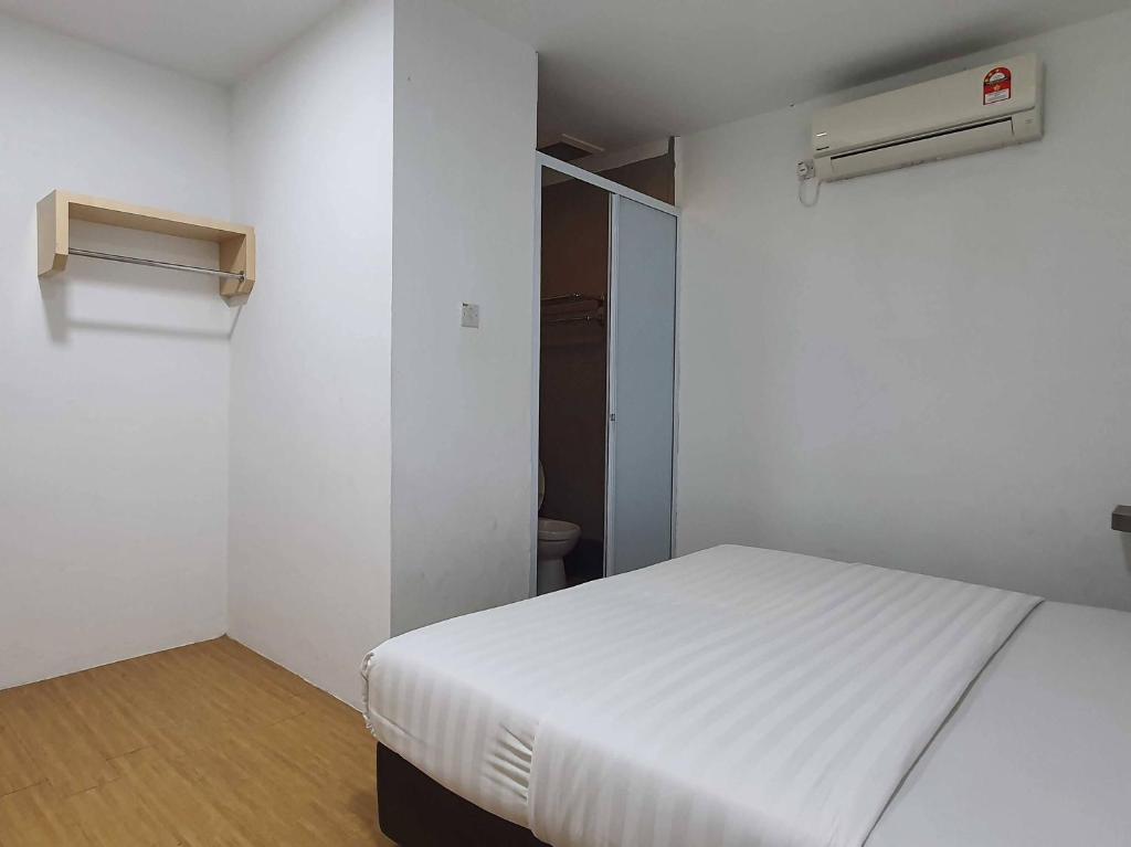 Postel nebo postele na pokoji v ubytování OYO 91053 Signature Inn Miri