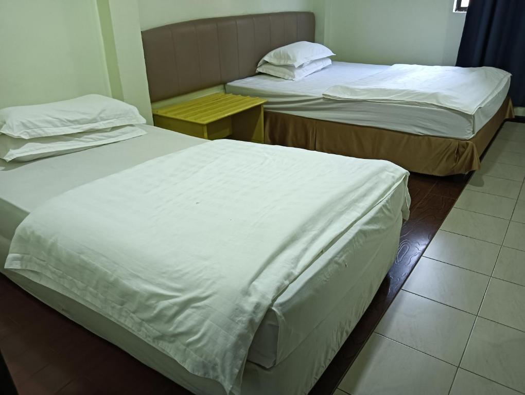 Postel nebo postele na pokoji v ubytování OYO 90809 Oriental Hotel