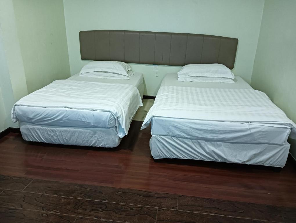 Postel nebo postele na pokoji v ubytování OYO 90809 Oriental Hotel