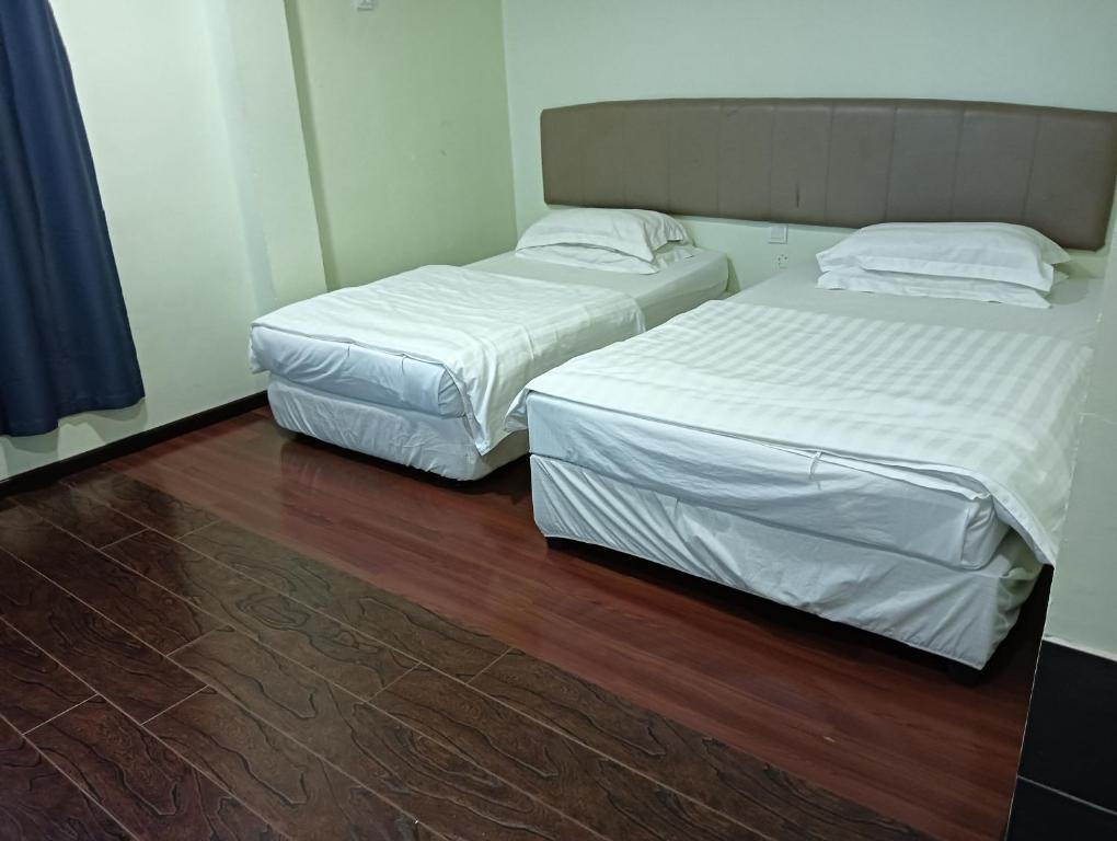 Postel nebo postele na pokoji v ubytování OYO 90809 Oriental Hotel