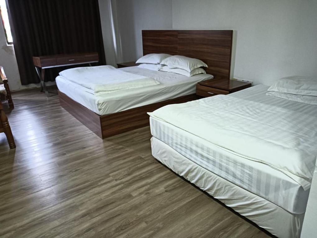 Postel nebo postele na pokoji v ubytování OYO 90809 Oriental Hotel