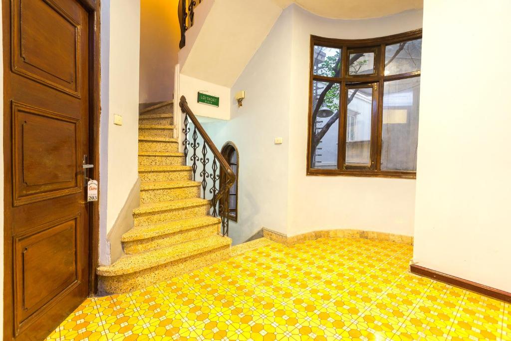a staircase in a house with a yellow tile floor at Chikoo Homestay spot-on in Hanoi