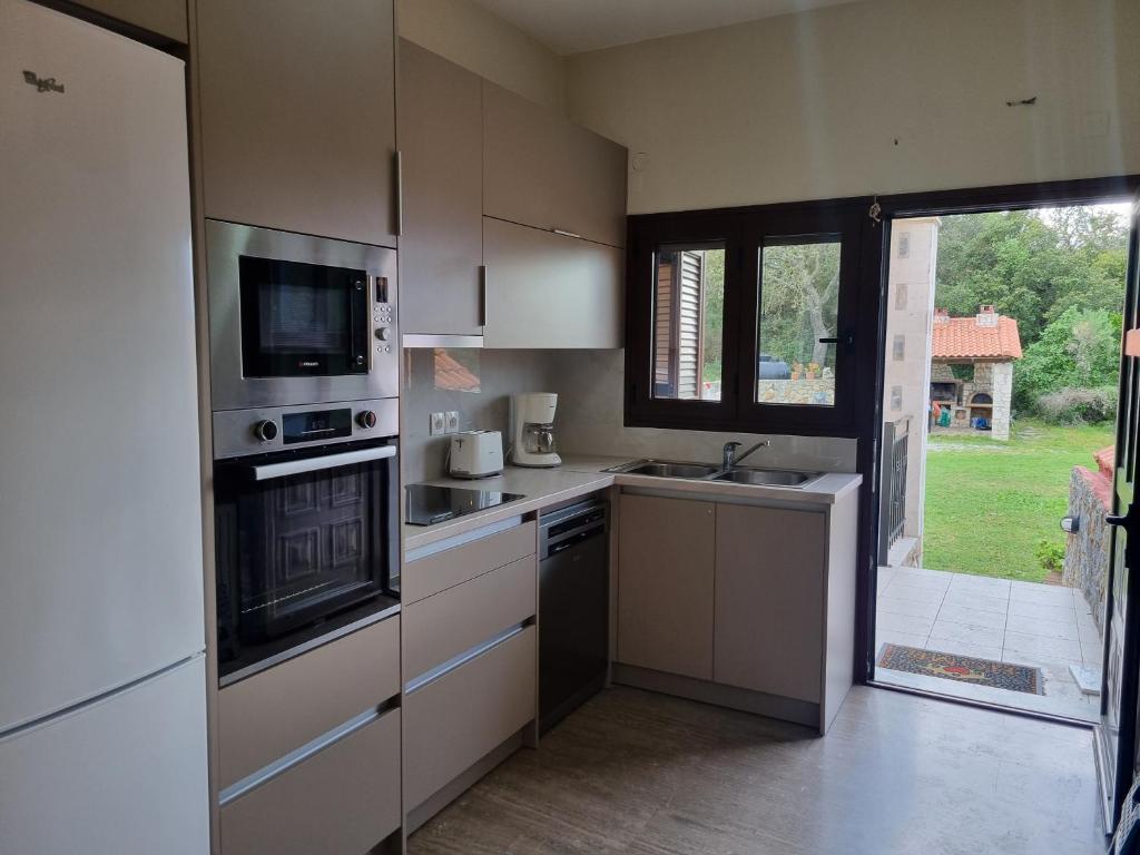 A kitchen or kitchenette at Aphrodite Villa