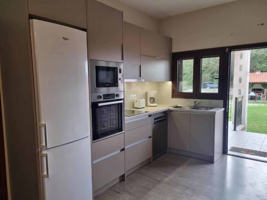 A kitchen or kitchenette at Aphrodite Villa