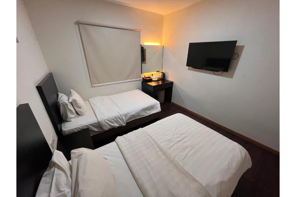 Postel nebo postele na pokoji v ubytování Grand World Hotel