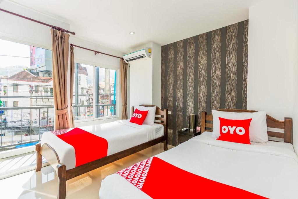 Postel nebo postele na pokoji v ubytování OYO 472 Tang Cheng Holiday Hotel