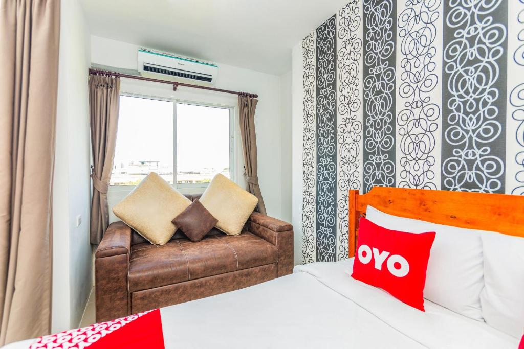 Postel nebo postele na pokoji v ubytování OYO 472 Tang Cheng Holiday Hotel