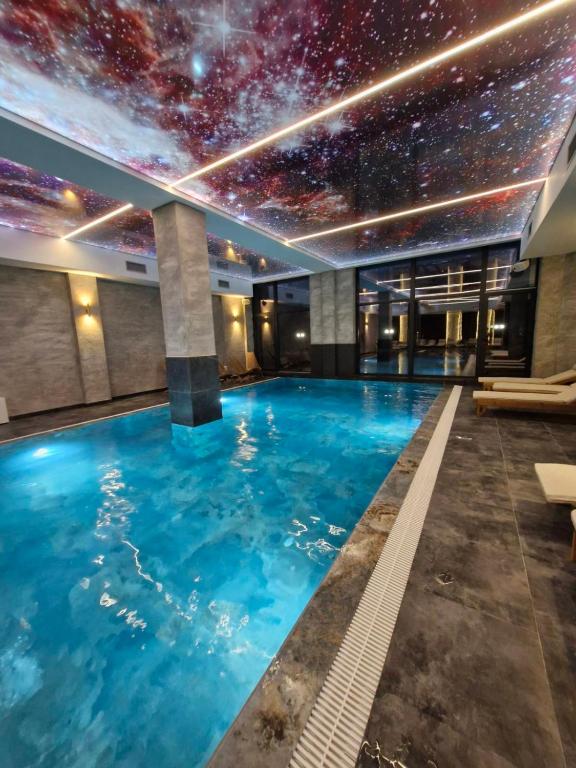 a swimming pool with a starry sky on the ceiling at RELAX RESIDENS-kopaonik in Kopaonik