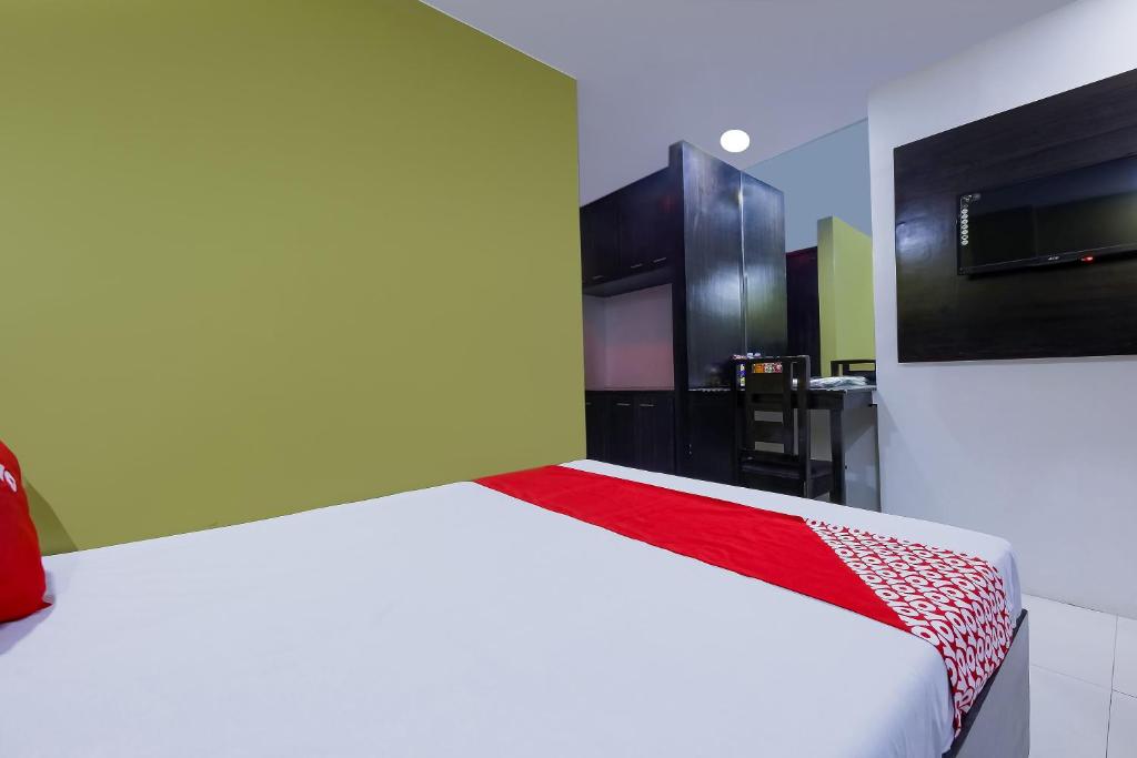 Postel nebo postele na pokoji v ubytování JQV Hotel