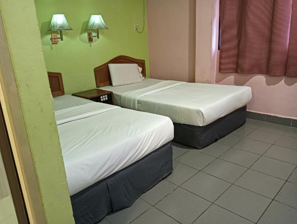 Postel nebo postele na pokoji v ubytování OYO 90860 Wawasan Inn