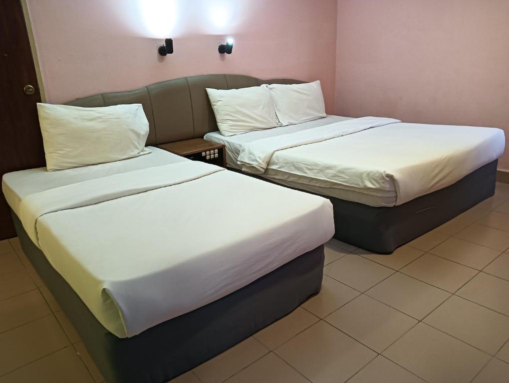 Postel nebo postele na pokoji v ubytování OYO 90860 Wawasan Inn