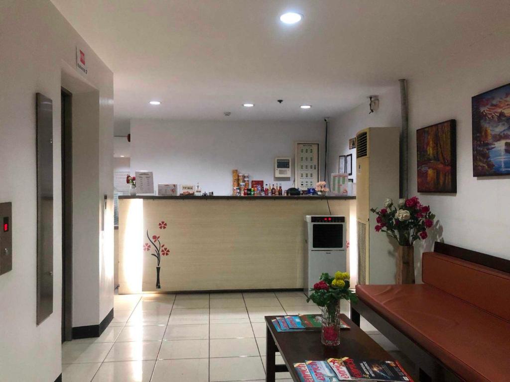 a living room with a kitchen with a garage at Camarin Prime Hotel in Manila
