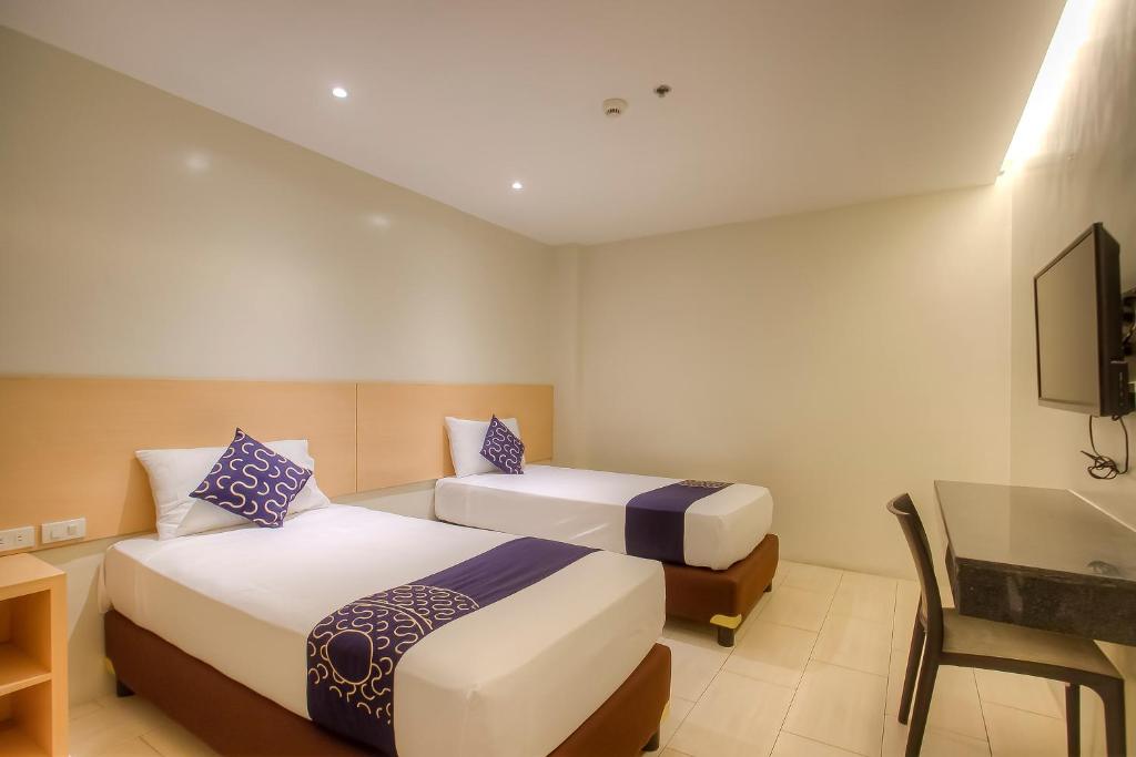 Postel nebo postele na pokoji v ubytování Capital O 827 Speciale Hotel