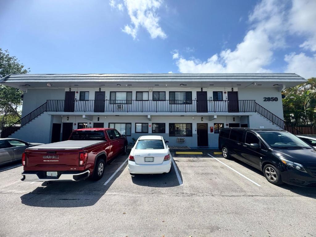 a building with cars parked in a parking lot at Bayview Apartments By Lowkl in Fort Lauderdale