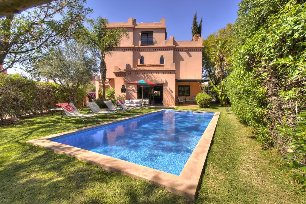 an image of a swimming pool in front of a house at VILLA Garden in Marrakesh