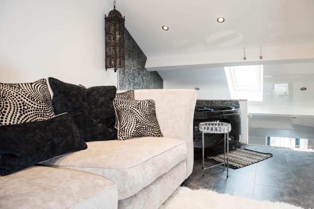 a living room with a couch and a table at The Penthouse in Kendal