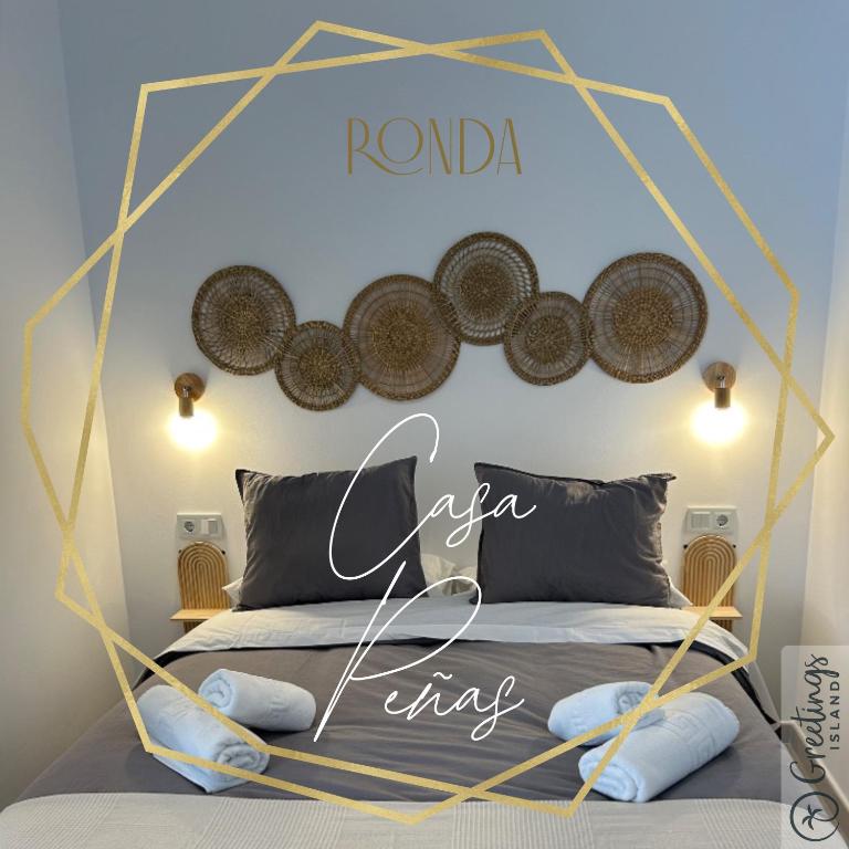 a bedroom with a bed with a sign on the wall at Casa Peñas 2 in Ronda