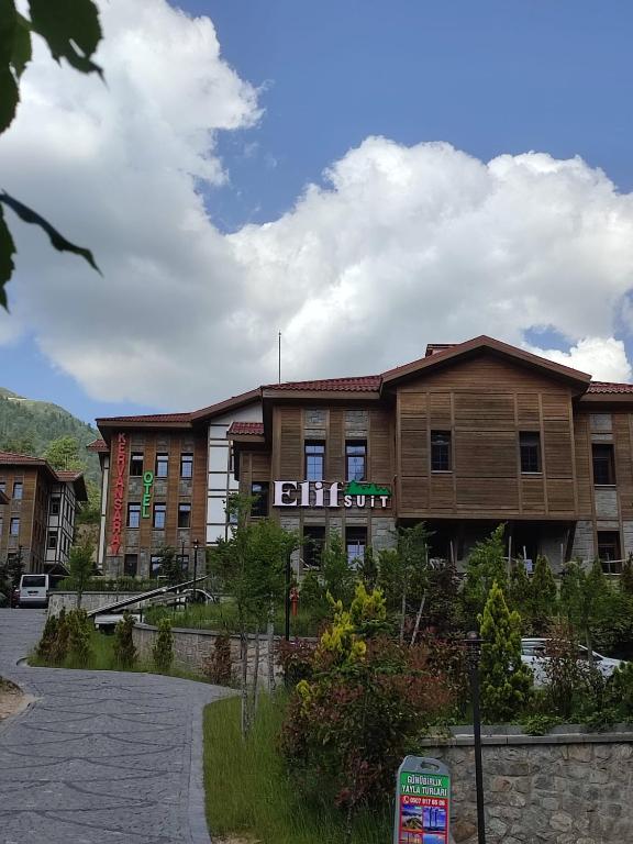 a building with a sign in front of it at Ayder Elif Apart Daire in Ayder Yaylasi