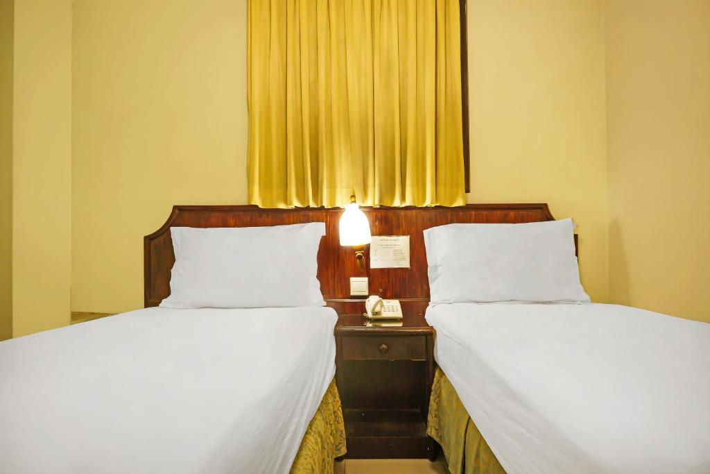 Postel nebo postele na pokoji v ubytování Super OYO Collection O 92690 Hotel Limas