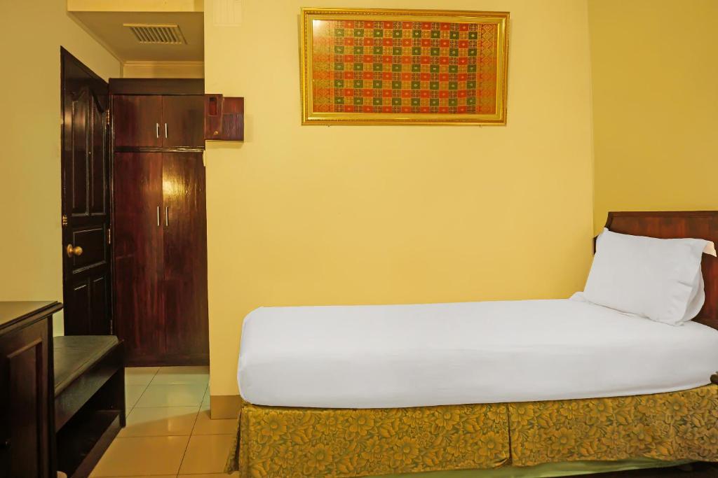 Postel nebo postele na pokoji v ubytování Super OYO Collection O 92690 Hotel Limas