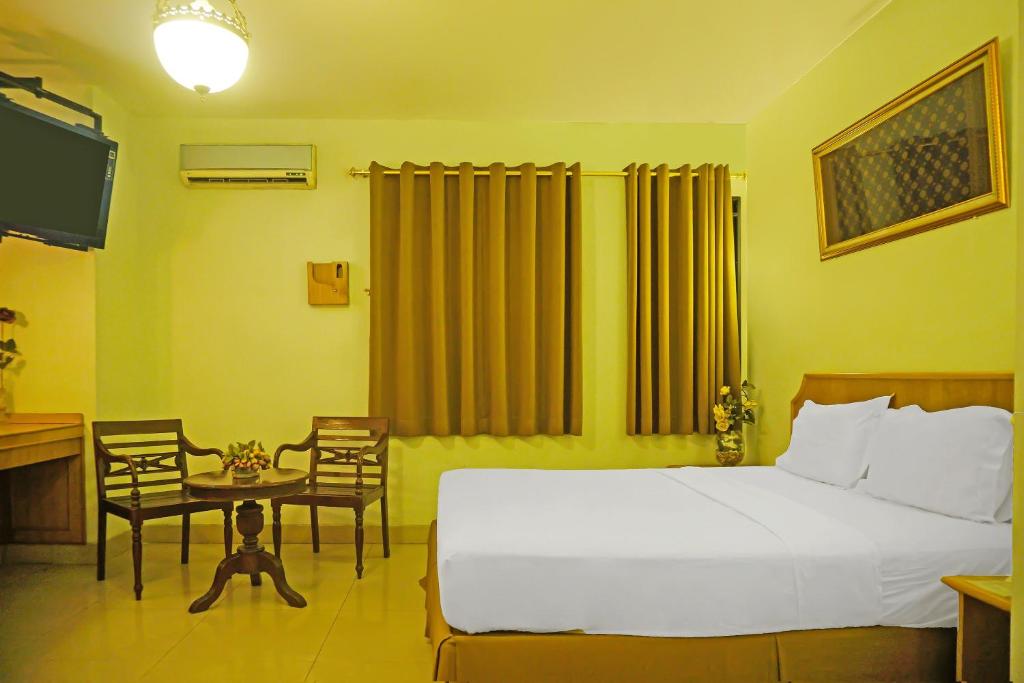 Postel nebo postele na pokoji v ubytování Super OYO Collection O 92690 Hotel Limas