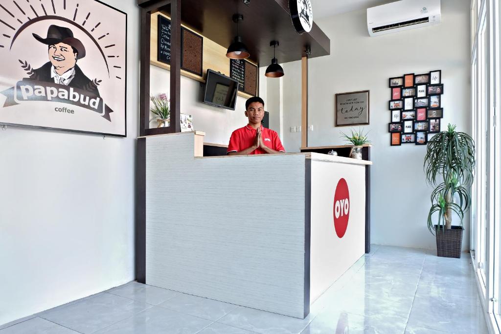 a man sitting at a counter in a restaurant at Super OYO 2756 Anata in Makassar