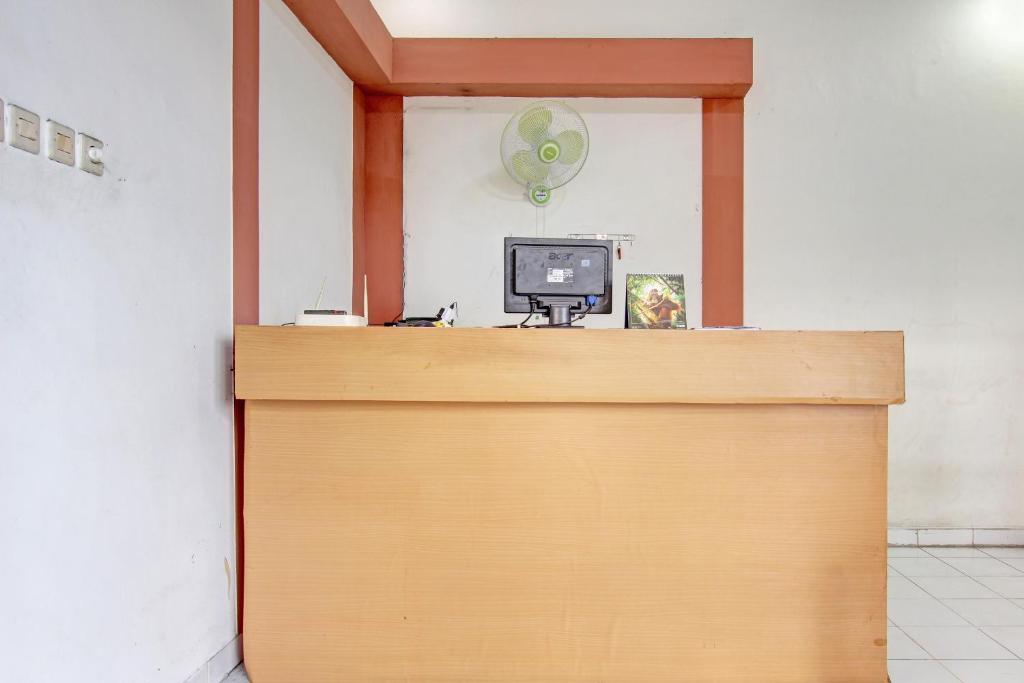 a wooden door with a computer on top of it at Hotel O Cindelaras B&b Bunk Bed in Piyungan