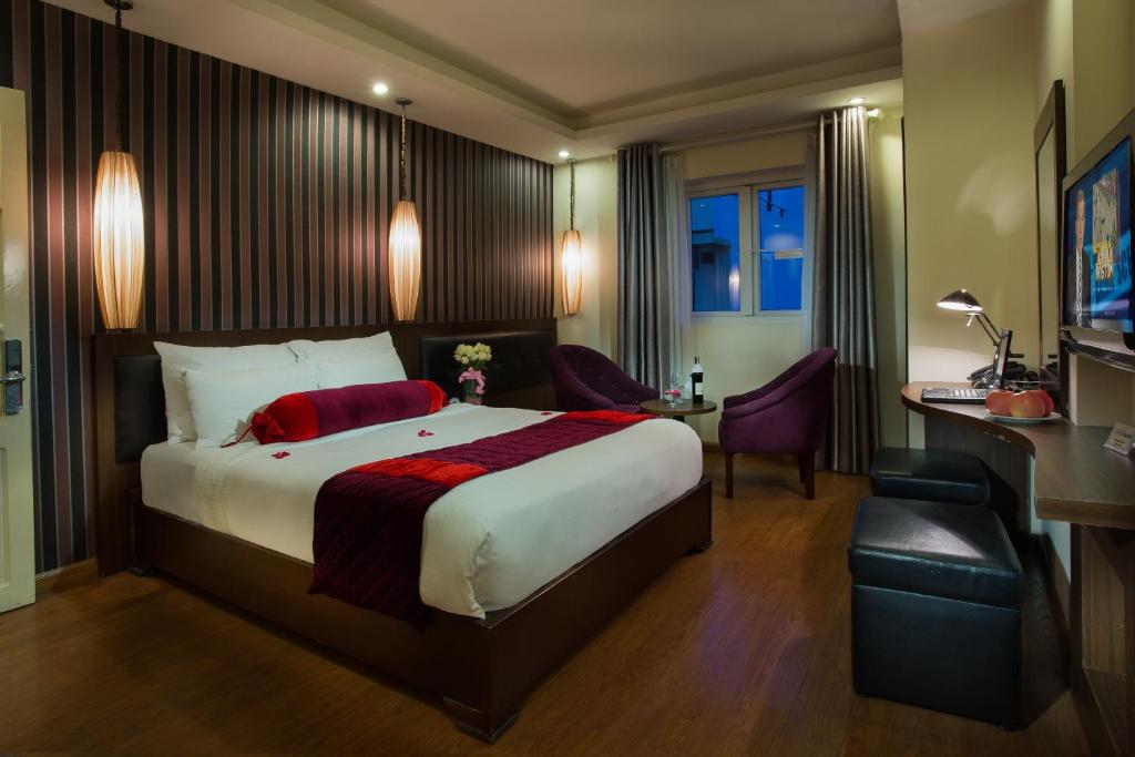 Postel nebo postele na pokoji v ubytování Golden Art Hotel