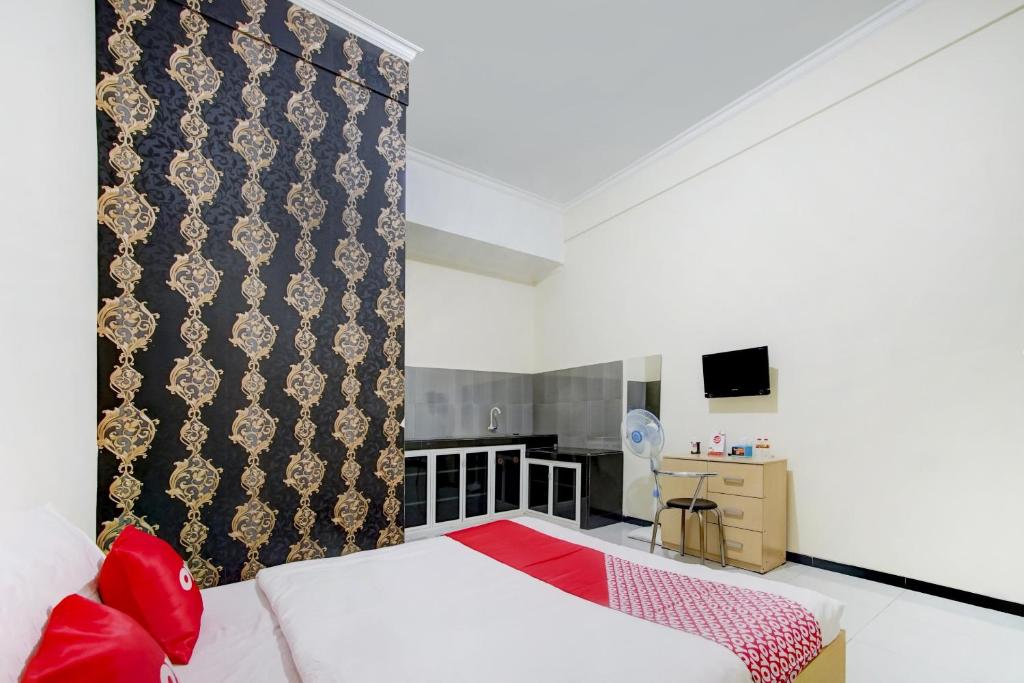 Postel nebo postele na pokoji v ubytování Super OYO Capital O 90151 Guest House 180