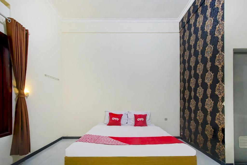 Postel nebo postele na pokoji v ubytování Super OYO Capital O 90151 Guest House 180